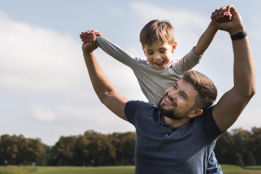 dad with son on shoulders