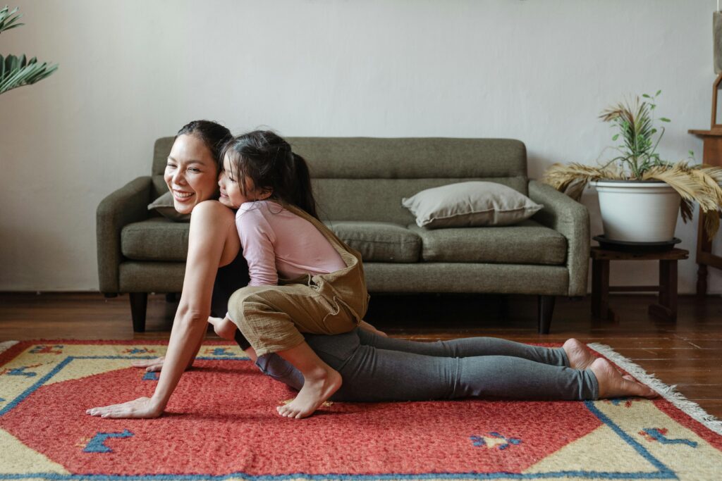Mother and young daughter doing yoga